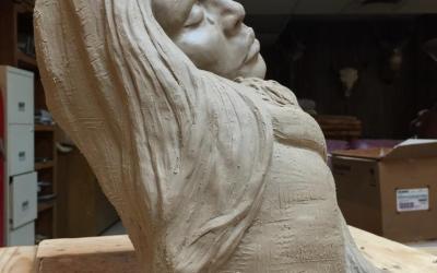 A sculpture of a woman with long hair