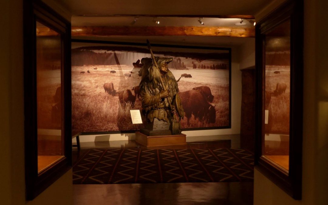 A large painting of an animal in the middle of a room.